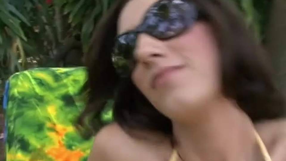 This brunette masturbates outside